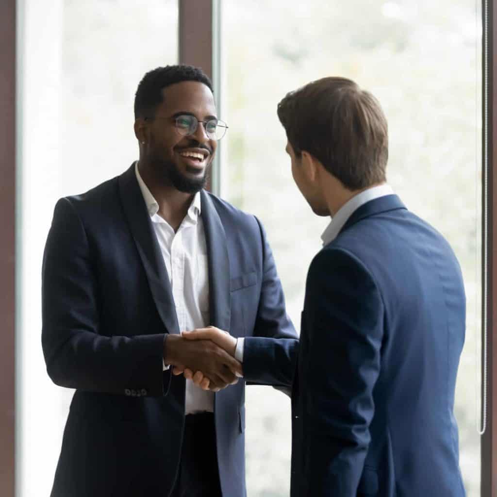 Happy business partners shaking hands